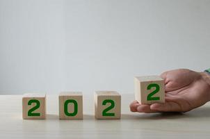 Number Ideas 2022 Happy New Year. The green number that the wooden cube is holding. photo