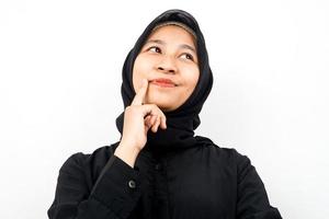 Closeup of beautiful young Muslim woman thinking, looking for ideas, looking at empty space, presenting something, isolated photo