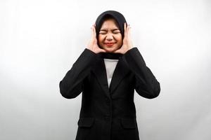 Beautiful young asian muslim business woman shocked, dizzy, stressed, unhappy, many problems, want solution, with  hands holding head isolated on white background photo