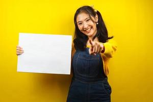 Pretty and cute young woman cheerful holding blank empty banner, placard, white board, blank sign board, white advertisement board, presenting something in copy space, promotion photo