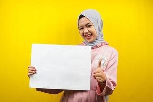 Pretty young muslim woman cheerful holding blank empty banner, placard, white board, blank sign board, white advertisement board, presenting something in copy space, promotion photo