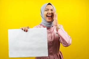 Pretty young muslim woman cheerful holding blank empty banner, placard, white board, blank sign board, white advertisement board, presenting something in copy space, promotion photo