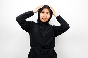 Beautiful young asian muslim woman shocked, surprised, wow expression, hands holding head, isolated on white background