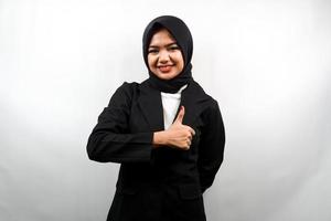 Beautiful young asian muslim business woman with thumbs up hand, ok sign, good job, success, congratulations, victory, smiling confident, enthusiastic and cheerful, looking at camera isolated photo