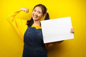 Pretty and cute young woman cheerful holding blank empty banner, placard, white board, blank sign board, white advertisement board, presenting something in copy space, promotion photo