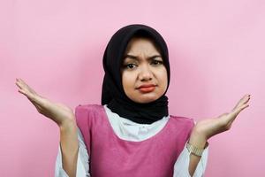 Closeup of beautiful young muslim woman with i don't know expression isolated photo