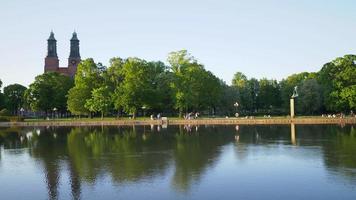 Eskilstuna, Sweden - May,2021. People relaxing by Kloster church park video