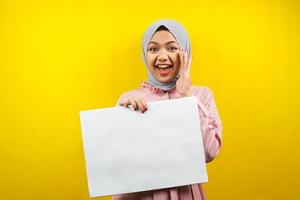 Pretty young muslim woman cheerful holding blank empty banner, placard, white board, blank sign board, white advertisement board, presenting something in copy space, promotion photo