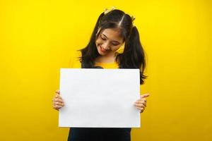 Pretty and cute young woman cheerful holding blank empty banner, placard, white board, blank sign board, white advertisement board, presenting something in copy space, promotion photo