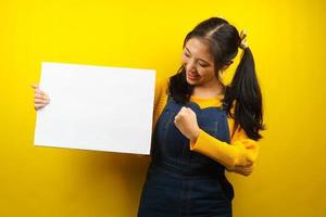 Pretty and cute young woman cheerful holding blank empty banner, placard, white board, blank sign board, white advertisement board, presenting something in copy space, promotion photo