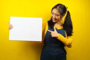 Pretty and cute young woman cheerful holding blank empty banner, placard, white board, blank sign board, white advertisement board, presenting something in copy space, promotion photo