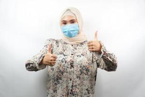Muslim woman wearing medical masks, anti corona virus movement, anti covid-19 movement, health movement using masks, with hands showing ok sign, good work, success, victory, isolated