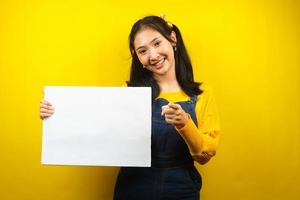 Pretty and cute young woman cheerful holding blank empty banner, placard, white board, blank sign board, white advertisement board, presenting something in copy space, promotion photo