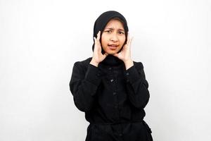 Beautiful young asian muslim woman shocked, surprised, wow expression, with hands holding cheek, isolated on white background