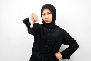 Beautiful young asian muslim woman pouting, belittling, disappointed, dissatisfied, not good, bad job, lousy, weak, looking at camera isolated on white background photo