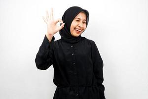Beautiful and cheerful young asian muslim woman, with okay hands, good work, victory, isolated on white background
