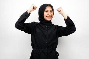 Beautiful asian young muslim woman with raised muscles, strength sign arms, isolated on white background photo