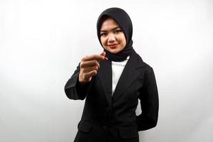 Beautiful young asian muslim business woman smiling, with korean love sign hand, hand close to camera, isolated on white background photo