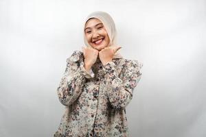 Beautiful young asian muslim woman smiling happy, cute, feeling comfortable, feeling cared for, feeling good, with hands holding chin isolated on white background photo
