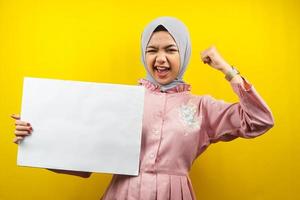 Pretty young muslim woman cheerful holding blank empty banner, placard, white board, blank sign board, white advertisement board, presenting something in copy space, promotion photo