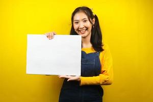 Pretty and cute young woman cheerful holding blank empty banner, placard, white board, blank sign board, white advertisement board, presenting something in copy space, promotion photo