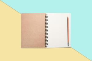 Notebook and pen on  colore background photo