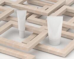 Squeeze tube for applying cream or makeup on white background and wooden block. photo