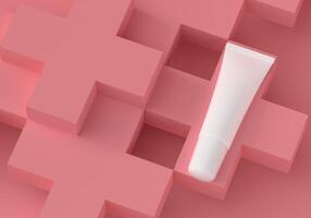Squeeze tube for applying cream or cosmetics on a pastel pink background. photo