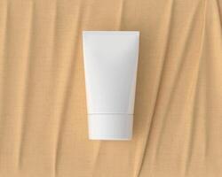 Squeeze tube for applying cream or cosmetics on a pastel orange background. photo