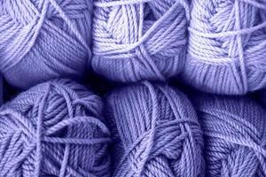 Many balls of wool yarn for knitting. Trendy color of year 2022.