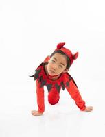 Portrait Asian little cute girl in evil costume for Halloween festival with pumpkin photo