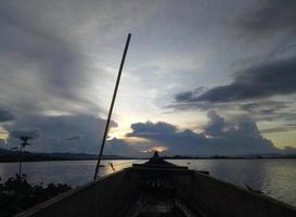 a traditional fishing boat anchored on the shore of Limboto Lake, Gorontalo. photo