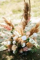wedding ceremony area with dried flowers in a meadow in a forest photo