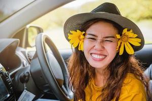 Asian women are on vacation. Drive happily traveling to the Mexican sunflower flower garden in Thailand. photo