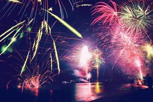 Background festive New Year with fireworks and bokeh. New Year fireworks on the beach. photo