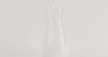 vista frontal, leite branco puro derramado em uma jarra de vidro transparente. com fundo branco.