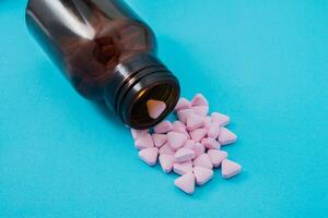 Medical pills spilling out of a toppled from pill bottle photo