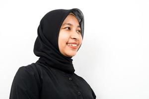 Closeup of beautiful cheerful young Muslim woman, looking at empty space, presenting something, isolated photo