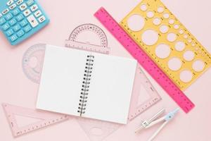 math rulers supplies with open empty notebook flat lay photo