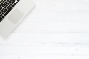 Minimal work space - Creative flat lay photo of workspace desk. Top view office desk with laptop on white wooden background. Top view with copy space, flat lay photography.