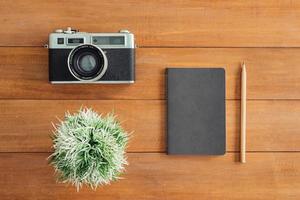 Minimal work space - Creative flat lay photo of workspace desk. Office desk wooden table background with mock up notebooks and retro camera. Top view with copy space, flat lay photography