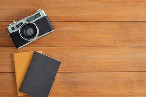 Minimal work space - Creative flat lay photo of workspace desk. Office desk wooden table background with mock up notebooks and retro camera. Top view with copy space, flat lay photography