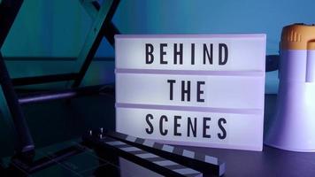 Behind the scene letters on cinema light box. Black text on white LED lightbox video