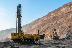 open cast mine dump trucks drive alone industrial area of iron ore quarry photo