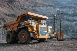 open cast mine dump trucks drive alone industrial area of iron ore quarry photo