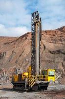 open cast mine dump trucks drive alone industrial area of iron ore quarry photo