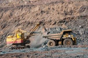 open cast mine dump trucks drive alone industrial area of iron ore quarry photo