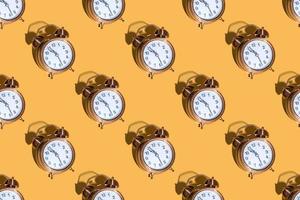 Alarm clock on a colored background hard shadows. Close up. Seamless patterns photo