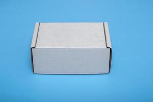 cardboard white box isolated on blue background. layout.mock-up photo