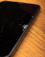 cracks on the screen of a modern smartphone macro broken cell phone